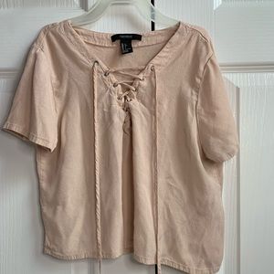 Blush pink, criss-cross tied shirt. Thin material